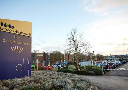 a sign in front of a parking lot with cars at Thistle London Heathrow Terminal 5 in Hillingdon