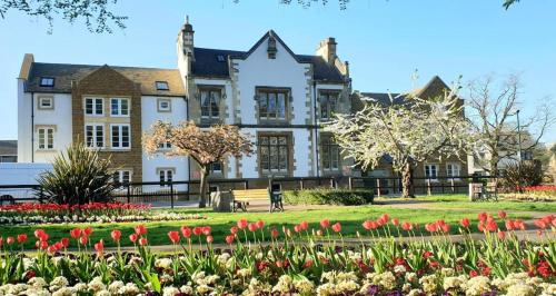 a large house with flowers in front of it at Flat 3- The Warwick in Banbury