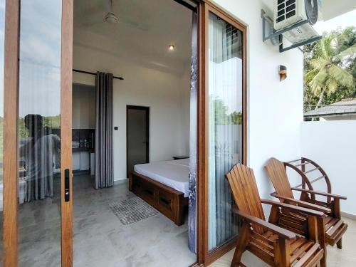 a bedroom with a bed and a chair and a mirror at Calvian Villa in Walliwala East