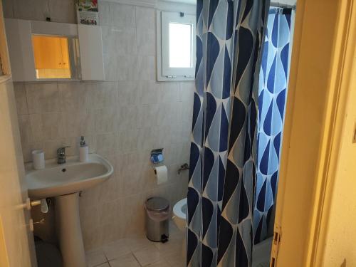 a small bathroom with a sink and a toilet at A & P Apartment in Xanthi