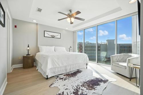 a bedroom with a bed and a chair and a large window at New 2 Bed 2 Bath Condo with Pool at BMS in Bristol