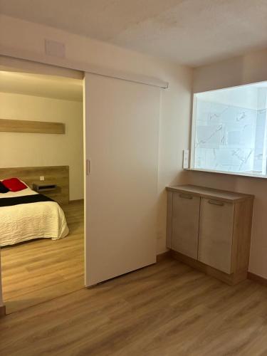 a bedroom with a bed and a large window at sol appart hotel in Banyuls-sur-Mer