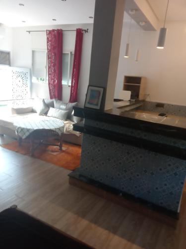 a living room with a couch and a table at Suite in nice résidence in Rabat