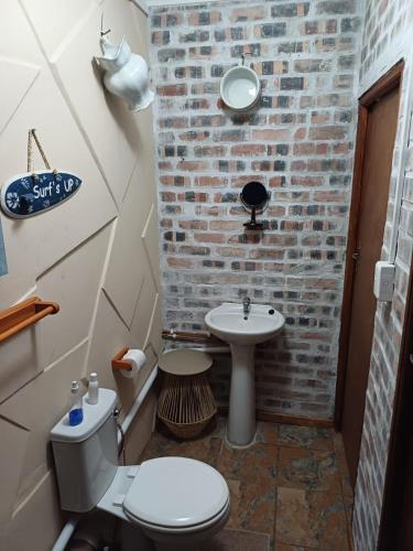 a bathroom with a white toilet and a sink at Gouritsmond Self Catering Units in Gouritzmond