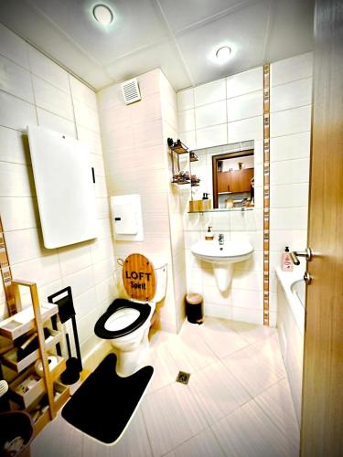 a bathroom with a toilet and a sink at Borovets luxury studio in Samokov