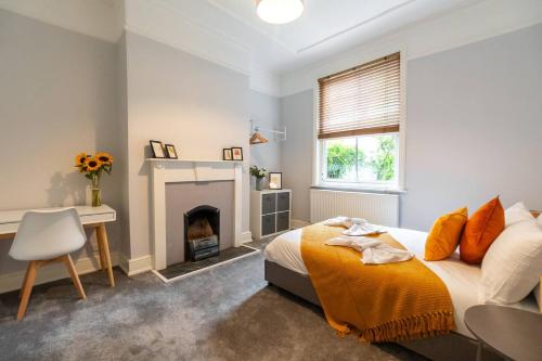 a bedroom with a bed and a fireplace at Spacious Victorian for 10 across Royal Infirmary in Leicester
