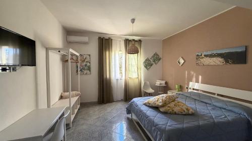 a bedroom with a bed and a television in it at A Casa di Giù B&B in Syracuse