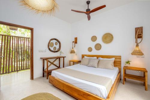 a bedroom with a bed and a window at Coconut Villas Zanzibar in Matemwe