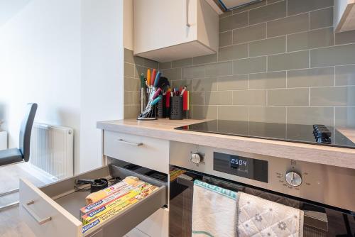 a kitchen with a counter and a stove top oven at Unique 2Bedroom Flats in Bicester in Bicester