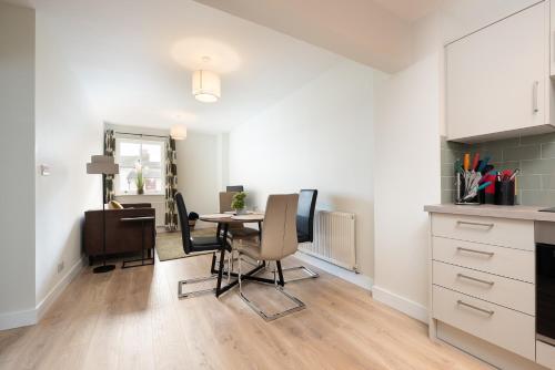 a kitchen and dining room with a table and chairs at Unique 2Bedroom Flats in Bicester in Bicester
