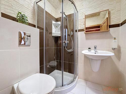 a bathroom with a shower and a toilet and a sink at Mia - Your Gozo Haven with Pool in Xagħra