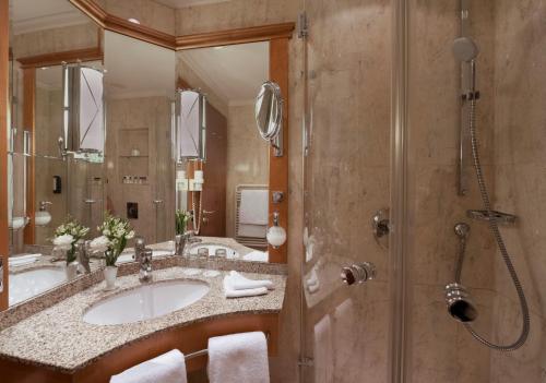 a bathroom with a sink and a shower at Potsdam Hotel Am Jägertor in Potsdam