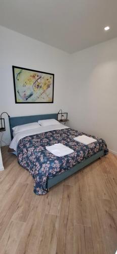 a bedroom with a bed with a floral bedspread at Casa Mafalda in Torre Boldone