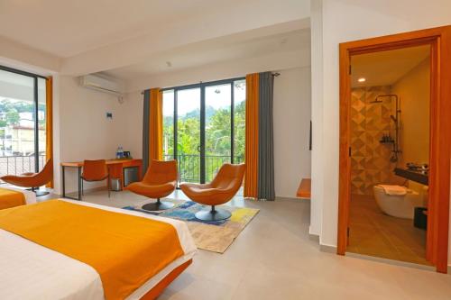 a hotel room with a bed and a bathroom at Sun Top Grand in Ella