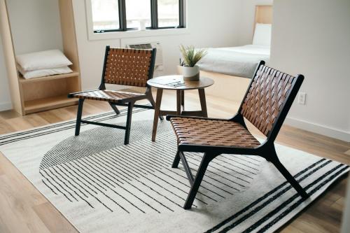 two chairs and a table in a room with a bed at Outbounder in Bayfield