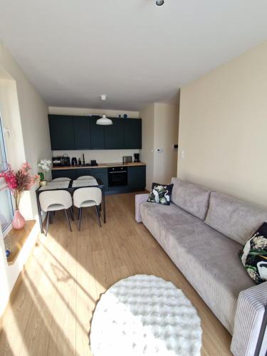 a living room with a couch and a table at Apartament Potockiego Private Parking Faktura in Rzeszów