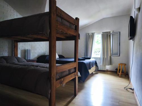 a bedroom with two bunk beds and a window at B&B Copahue in San Carlos de Bariloche