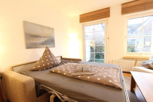 a bed in a room with lights on it at MeerGlück in Langeoog