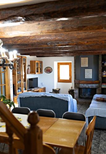 a living room with a blue couch and a table at Cal Fortic, Navès in Navés