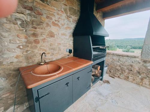 a kitchen with a sink and a stove at Cal Fortic, Navès in Navés