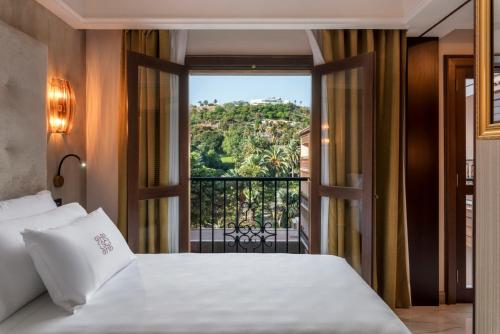a bedroom with a bed and a window with a view at Santa Catalina, a Royal Hideaway Hotel - Gran Lujo in Las Palmas de Gran Canaria