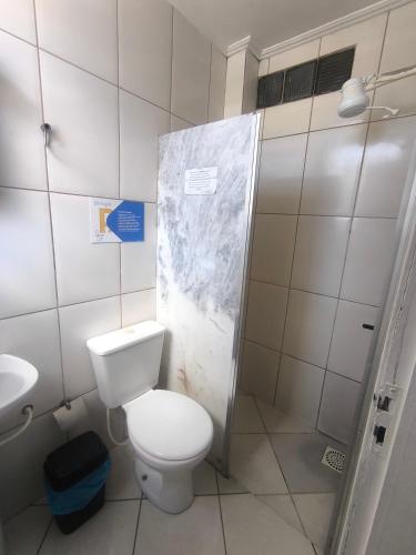 a small bathroom with a toilet and a shower at Hotel Portugal in Macaé