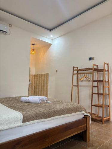 a bedroom with a bunk bed with a ladder at Gili Glow Homestay in Gili Trawangan