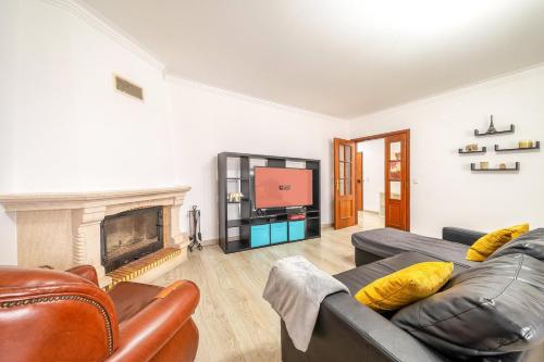 a living room with a couch and a fireplace at GuestReady – Alcochete Views & Comfort in Alcochete