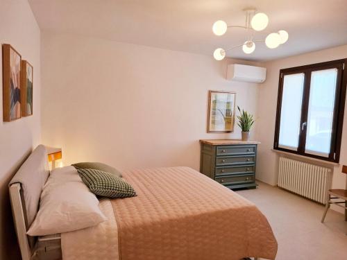 a bedroom with a bed and a dresser and a window at Podere Radici - Room & Breakfast in Misano Adriatico