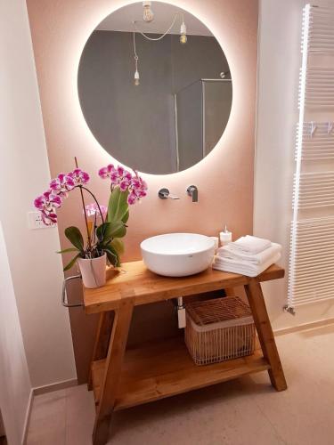 a bathroom with a sink and a mirror at Podere Radici - Room & Breakfast in Misano Adriatico
