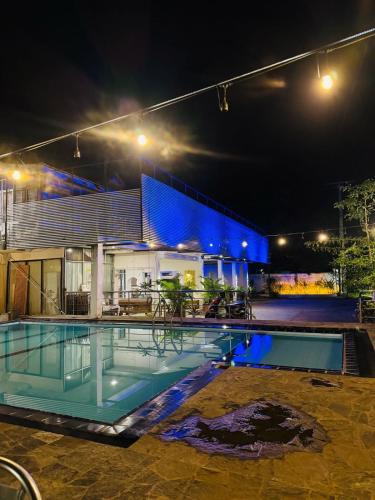 a house with a swimming pool at night at Hotel Ruwan in Kataragama