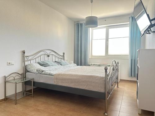 a bedroom with a bed and a window at Ferienwohnung in Neudenau