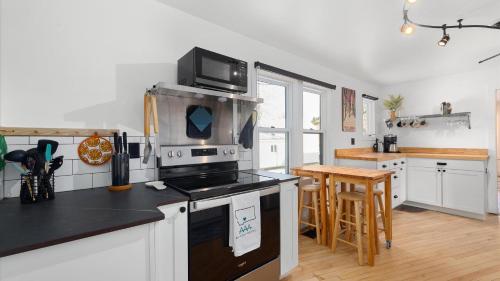 a kitchen with a stove and a microwave at Rio Ridge in Red Lodge