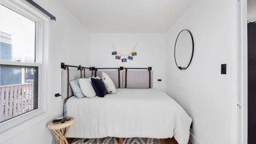 a bedroom with a bed with a mirror and a window at Rio Ridge in Red Lodge