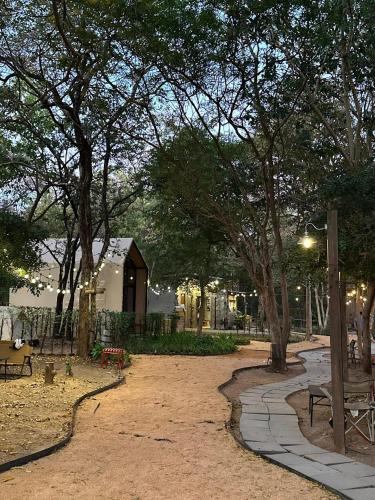 a park with benches and trees and a building at Cabin Home อยู่ป่า wild and free in Ko Larn