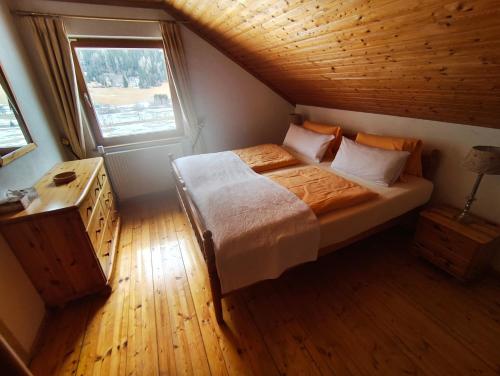 a bedroom with a bed and a window at Land - Haus in Pusterwald