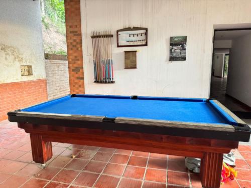 a blue pool table sitting on a brick floor at Hacienda Torcoroma in Bucaramanga
