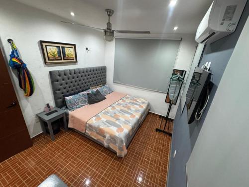 a bedroom with a bed in a small room at Casa Santa Cruz in Chetumal