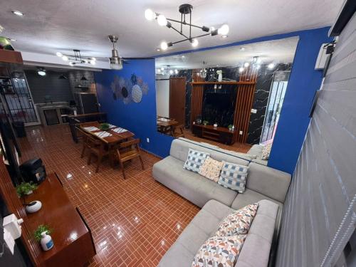 a living room with a couch and a table at Casa Santa Cruz in Chetumal
