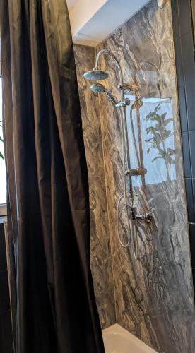 a shower in a bathroom with a shower curtain at Stadtnah an der Förde 7502 E in Flensburg