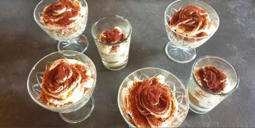 a group of glass bowls with dessert in them at B&B Chalet Il Picchio in Varzo