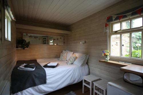 a bedroom with a bed in a small room at The Shepherd's Hut in Sheriff Hutton