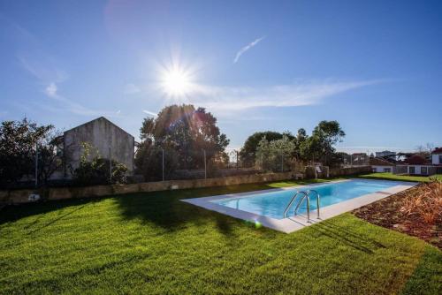 a swimming pool in the middle of a yard at Liiiving in Porto - Haven Pool Apartment in Porto