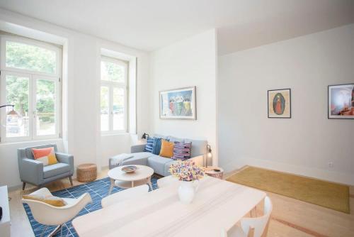a living room with a table and a couch at Liiiving in Porto - Haven Pool Apartment in Porto