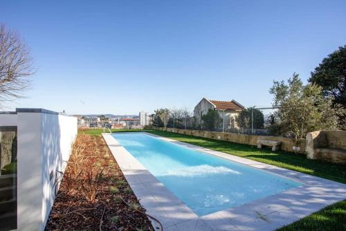 a swimming pool in the backyard of a house at Liiiving in Porto - Haven Pool Apartment in Porto