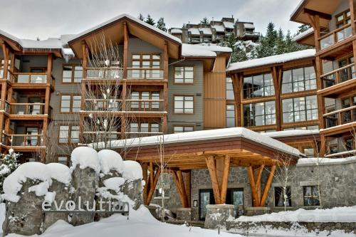 a large apartment building with snow on the ground at Evolution Whistler, by Lodging Ovations in Whistler