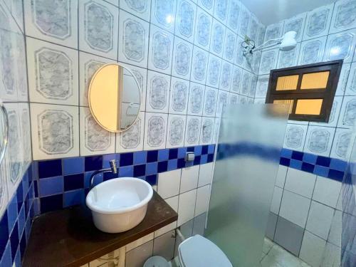 a bathroom with a sink and a toilet and a mirror at Nalu Suítes Maresias in Maresias
