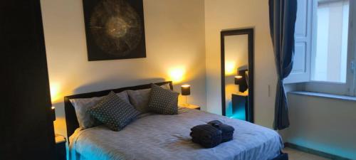 a bedroom with a bed with a backpack on it at The Reggia Nest in Caserta