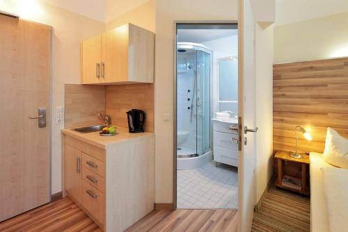 a small bathroom with a sink and a shower at Petul Apart Hotel City in Essen