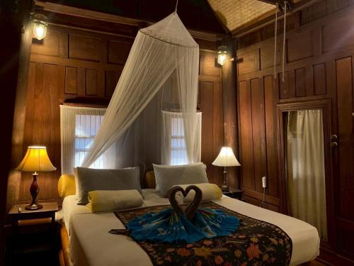 a bedroom with a bed with a heart on it at Sea Pines & Liberg in Nai Yang Beach